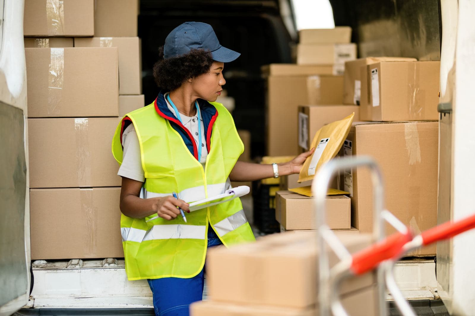 Courier checking packages at a delivery van