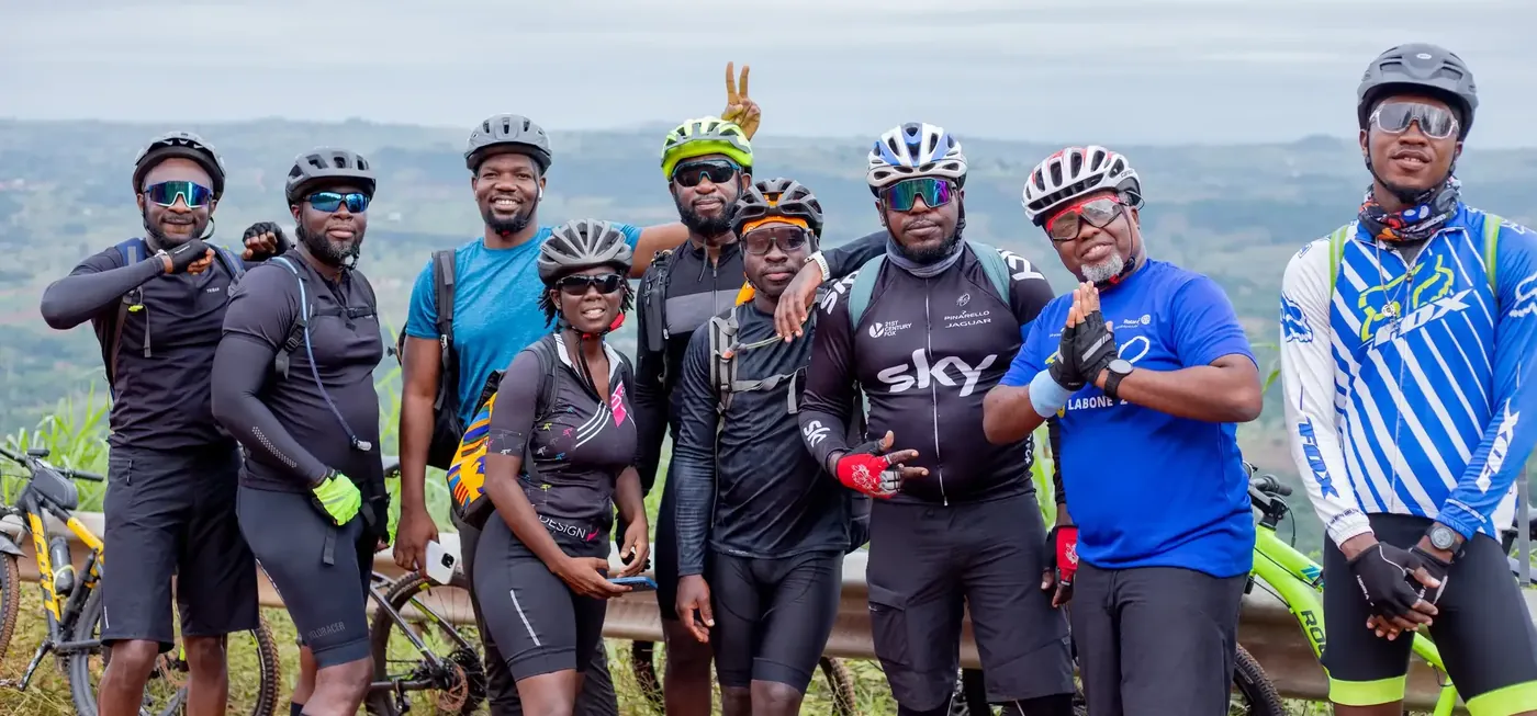 Trivoxo group biking tour — riders posing on a ridge overlooking the valley