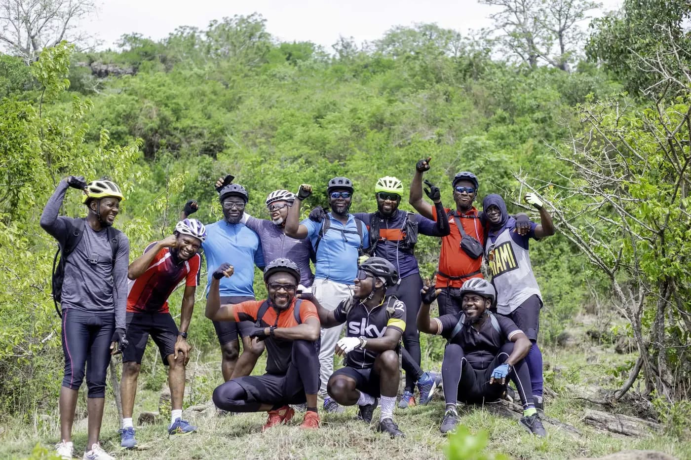 Trivoxo adventure event — group celebrating on a hillside trail
